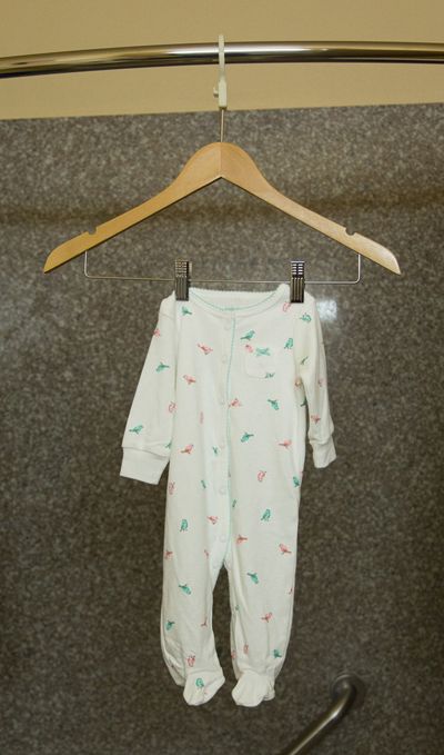 Baby clothes drying from a hanger using ConvertAHanger in a bathroom