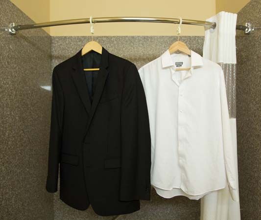 Jacket and shirt hanging in hotel bathroom for steaming