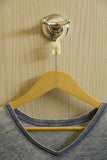 Anti Theft Hotel Hanger - Clothes hanging on bathroom door with the CovertAHanger